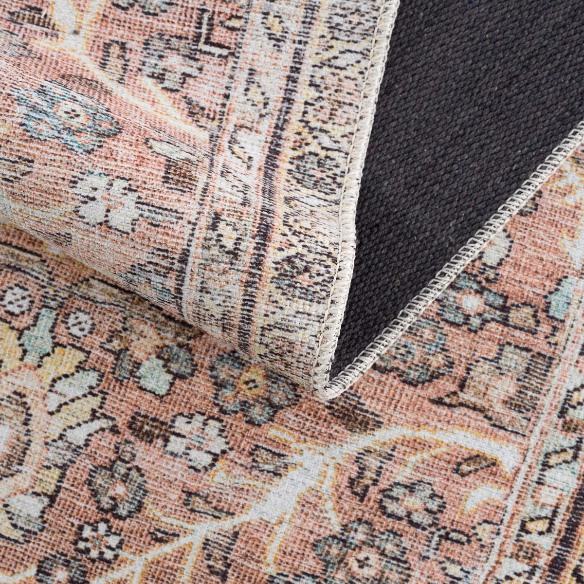 Hauteloom Urpi Rose and Brown washable area rug featuring a floral pattern in pink and earthy tones, ideal for living rooms or bedrooms.