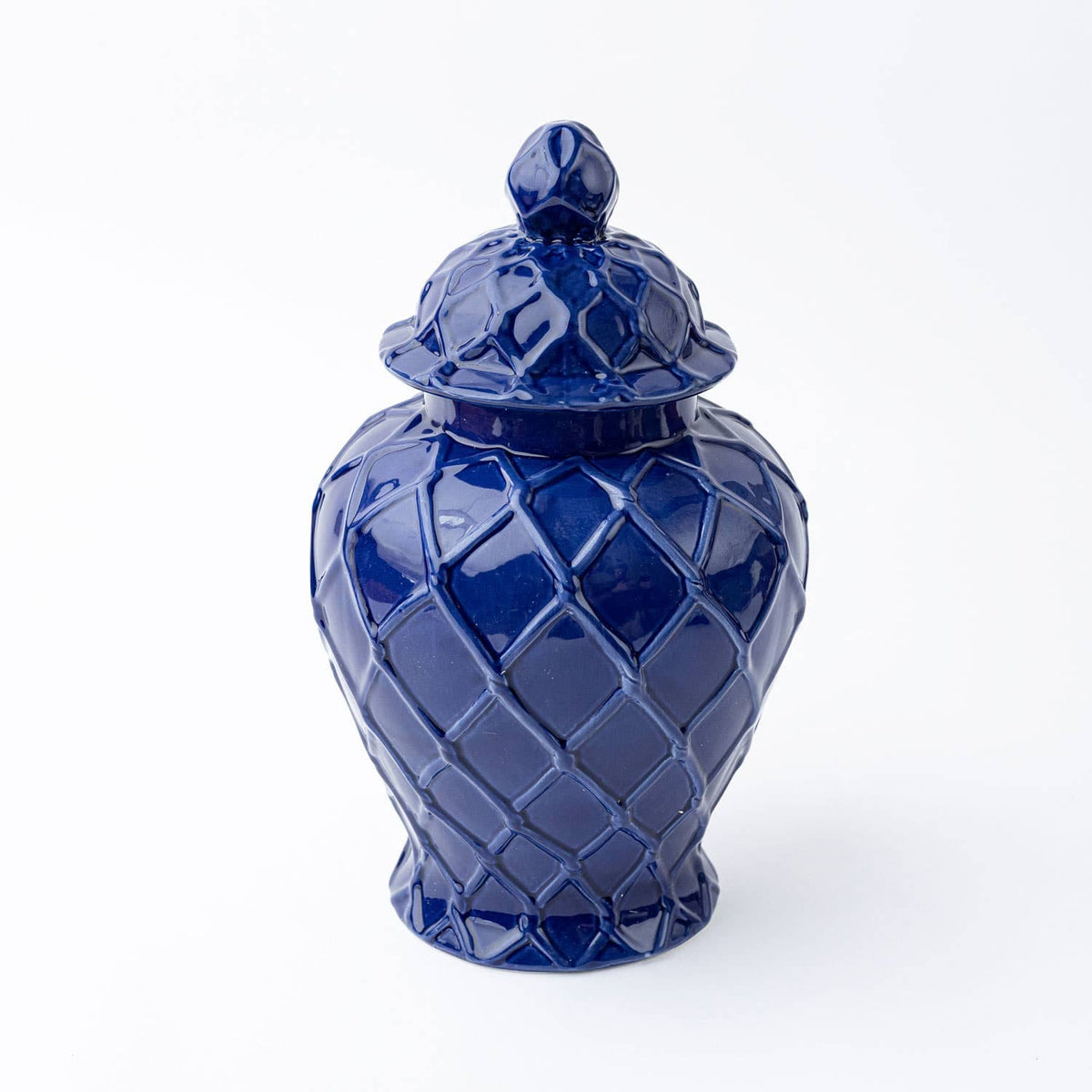Three navy textured ginger jars of different sizes, showcasing their detailed surface and elegant design.