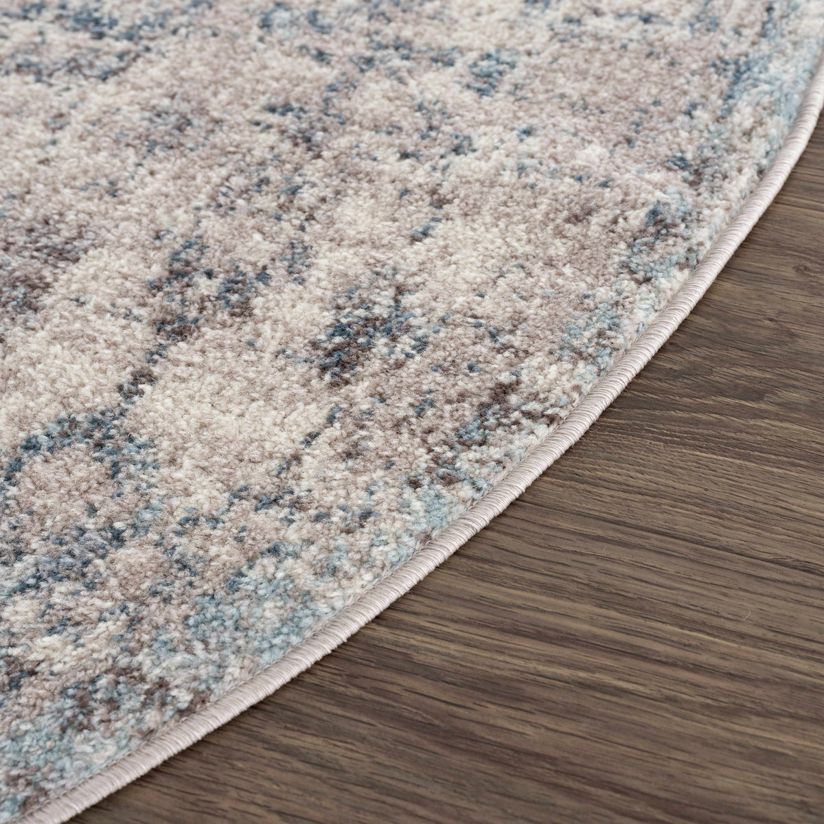 Corner view of a Boutique Rugs Orrick Area Rug with a red and beige geometric pattern on a hardwood floor.