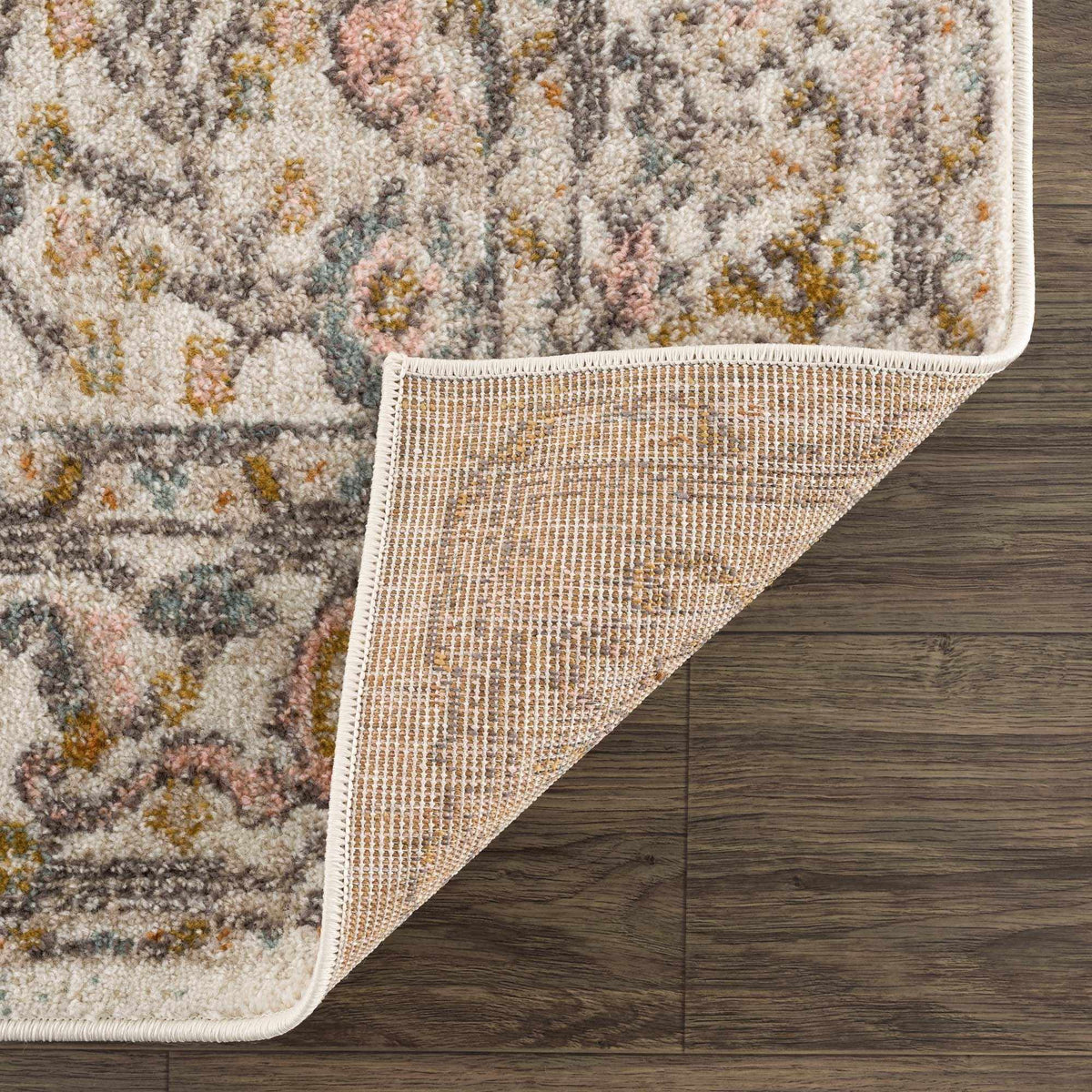 Folded Herstmonceux area rug by Boutique Rugs, showcasing intricate patterns and soft texture in neutral tones.