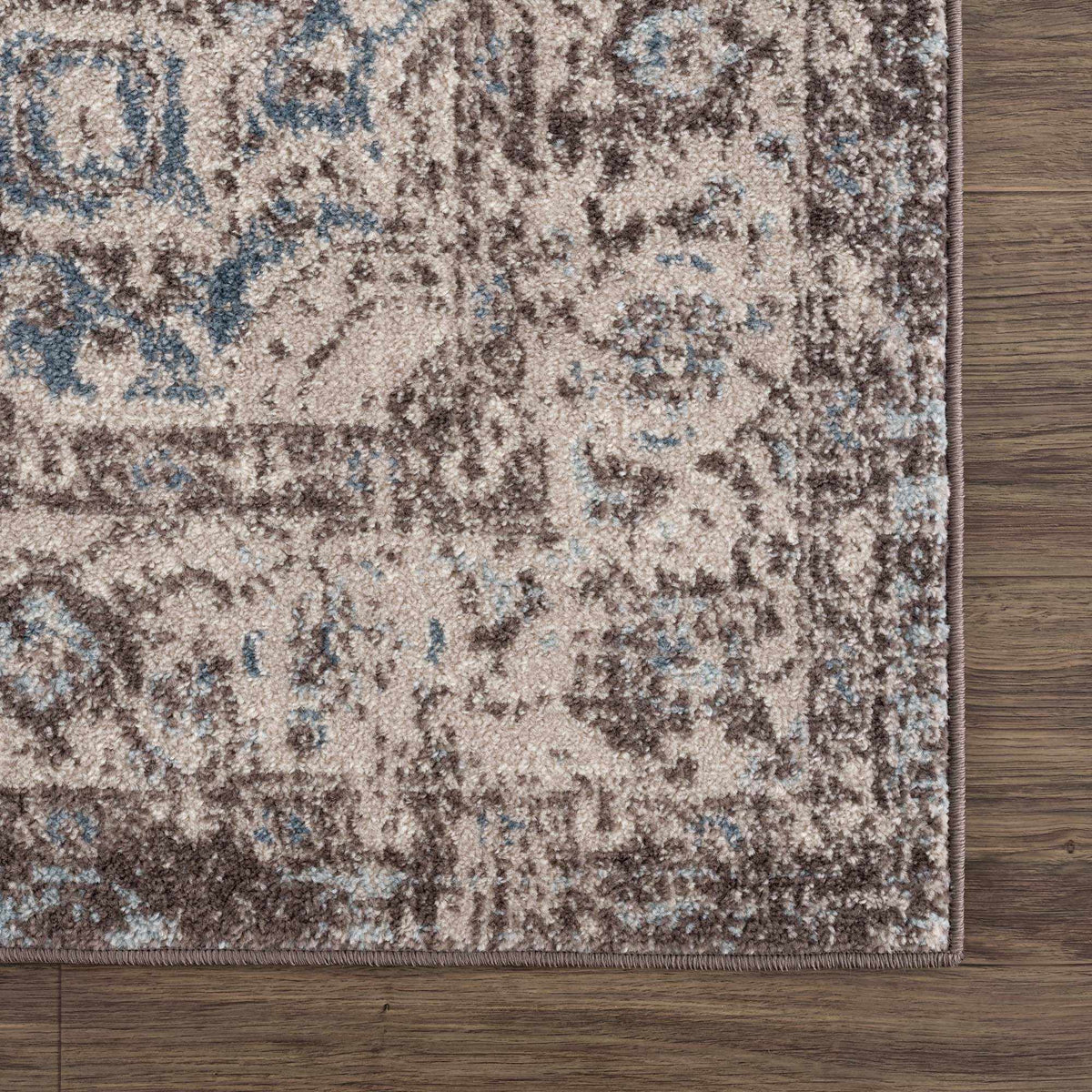 Dark brown medallion area rug by Hauteloom, corner view showing intricate pattern and textured design.