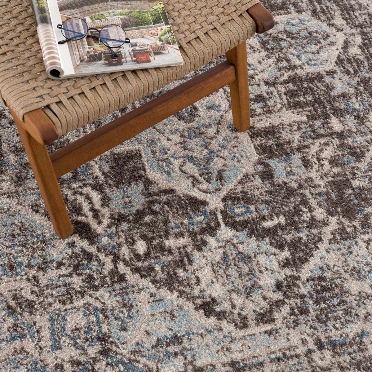 Dark brown medallion area rug by Hauteloom, featuring intricate patterns and a plush texture, shown in a stylish interior setting.