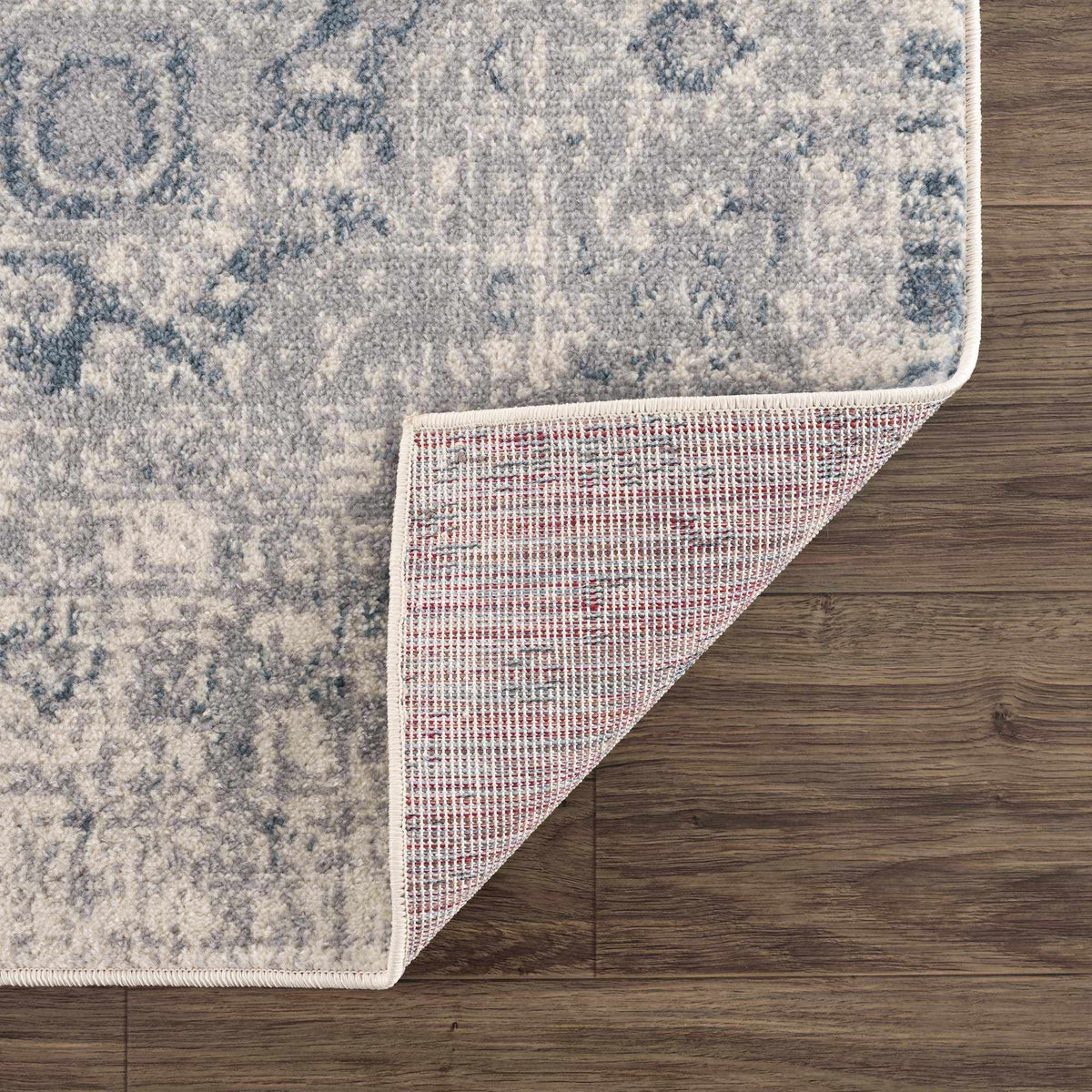 Hauteloom Peeta Gray Blue Medallion Area Rug with intricate medallion pattern and soft textured surface, shown folded in studio image.