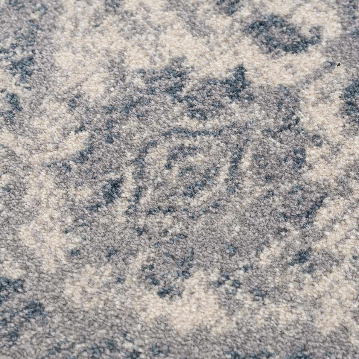 Gray and blue medallion area rug by Hauteloom with intricate pattern and textured surface, perfect for living or dining rooms.