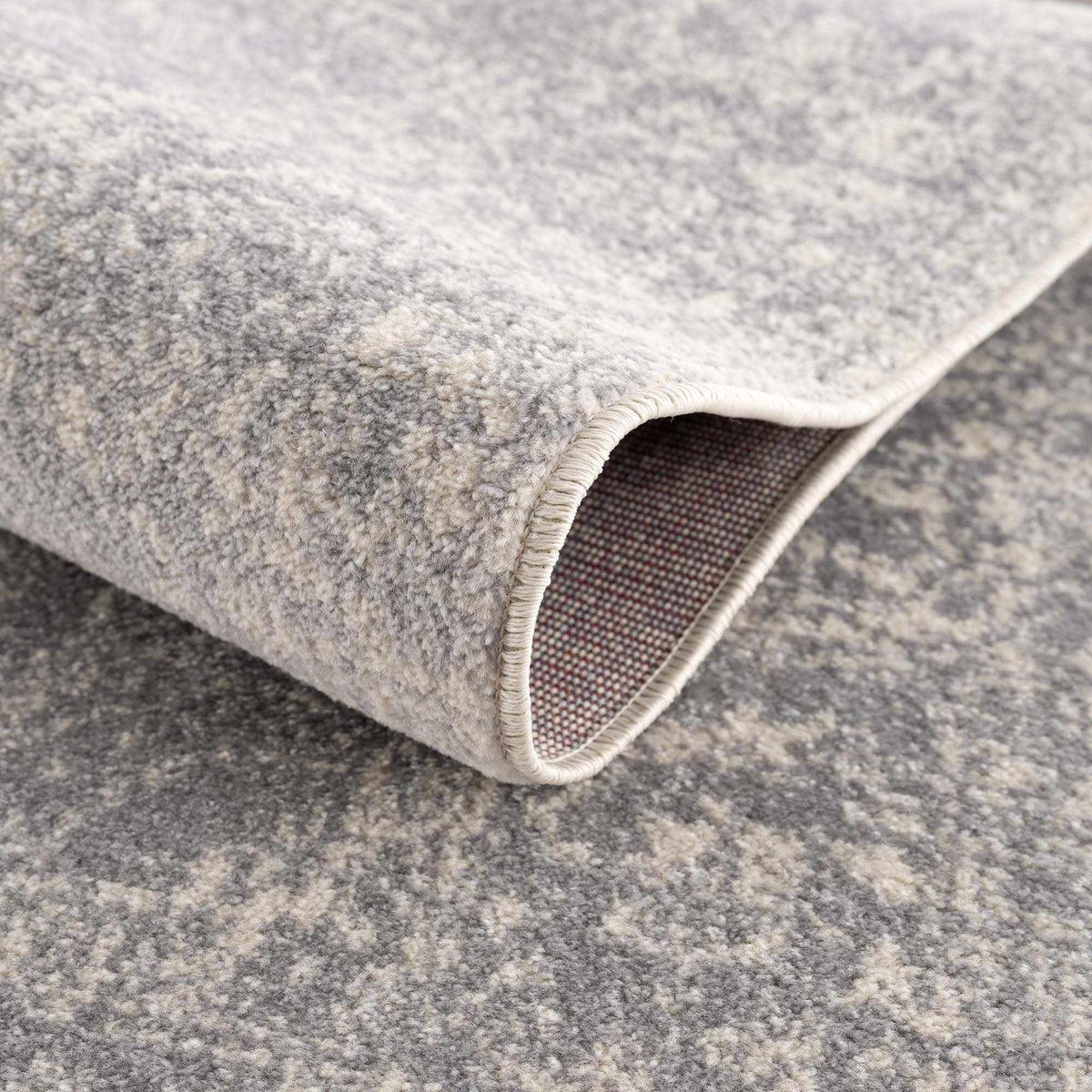 Hauteloom Peeta Gray Medallion Area Rug with intricate pattern, soft texture, and neutral tones, displayed on a wooden floor.