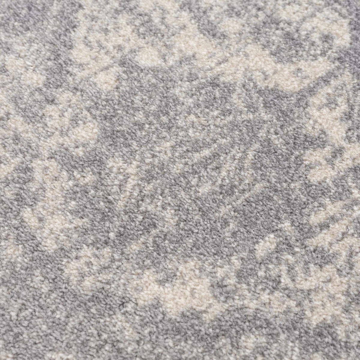 Peeta Gray Medallion Area Rug by Hauteloom featuring a textured gray medallion design on a neutral background.