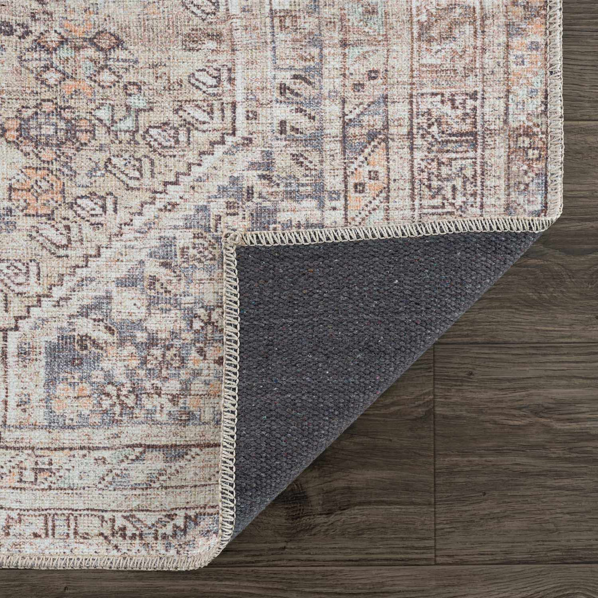 Folded Barny Tan washable area rug by Boutique Rugs, showcasing soft fabric and neutral color for cozy home decor.