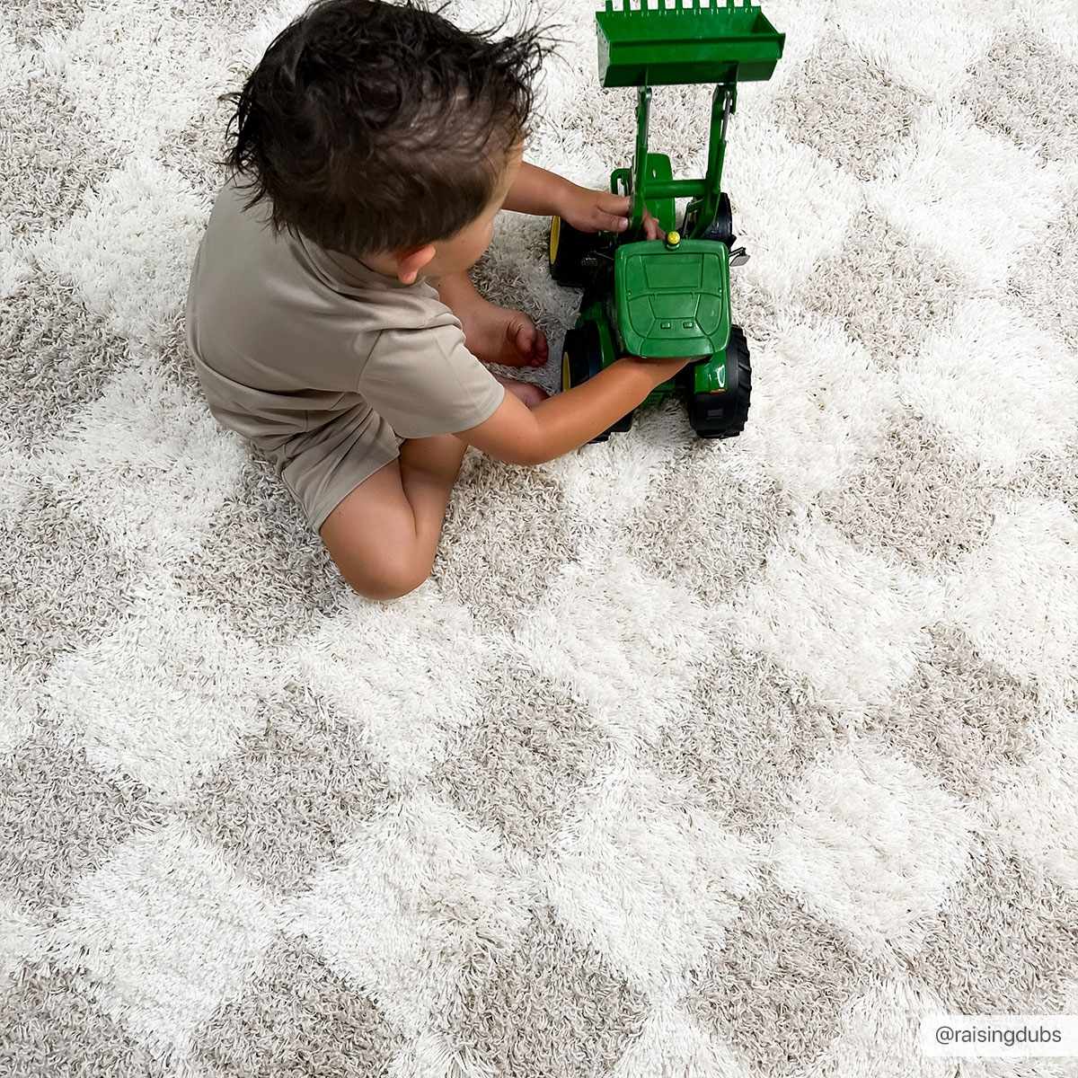 Light brown checkered area rug by Boutique Rugs, 8x10 size, showing a soft, patterned design suitable for living spaces.