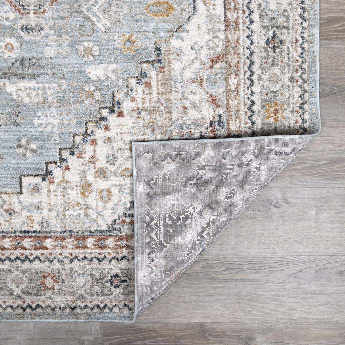 Gray and blue Kouta area rug by Boutique Rugs, showcasing a folded design with intricate patterns and soft texture.