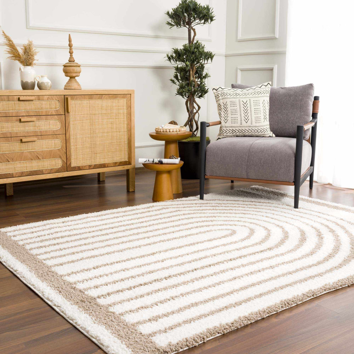 Jola beige area rug by Boutique Rugs displayed in a room scene, showcasing a soft, neutral-toned woven rug on the floor.