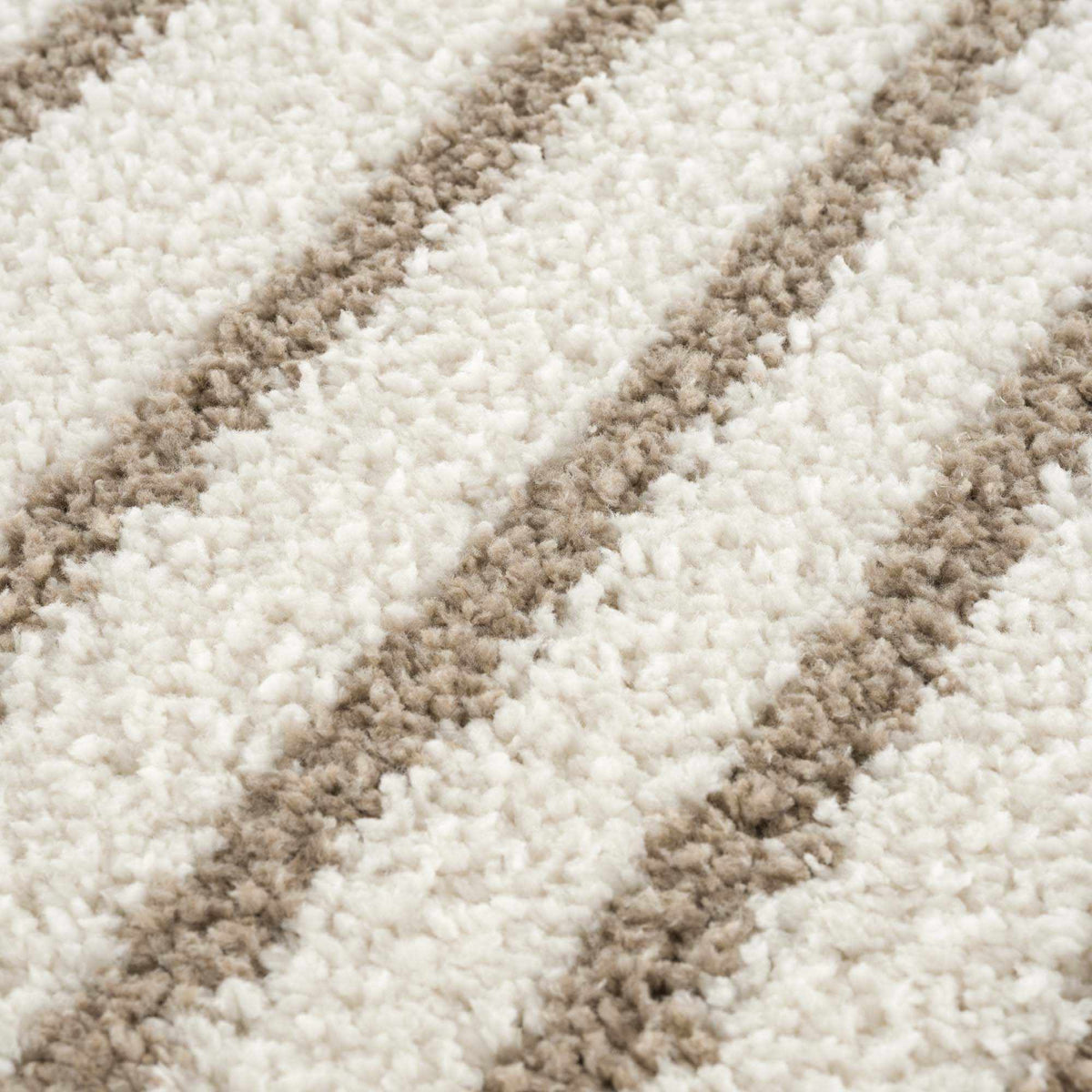 Textured beige Jola area rug from Boutique Rugs, showcasing soft fibers and intricate pattern in a modern living space setting.