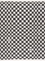 Black and white checkered shag rug by Boutique Rugs, featuring a plush, textured surface with bold geometric pattern.