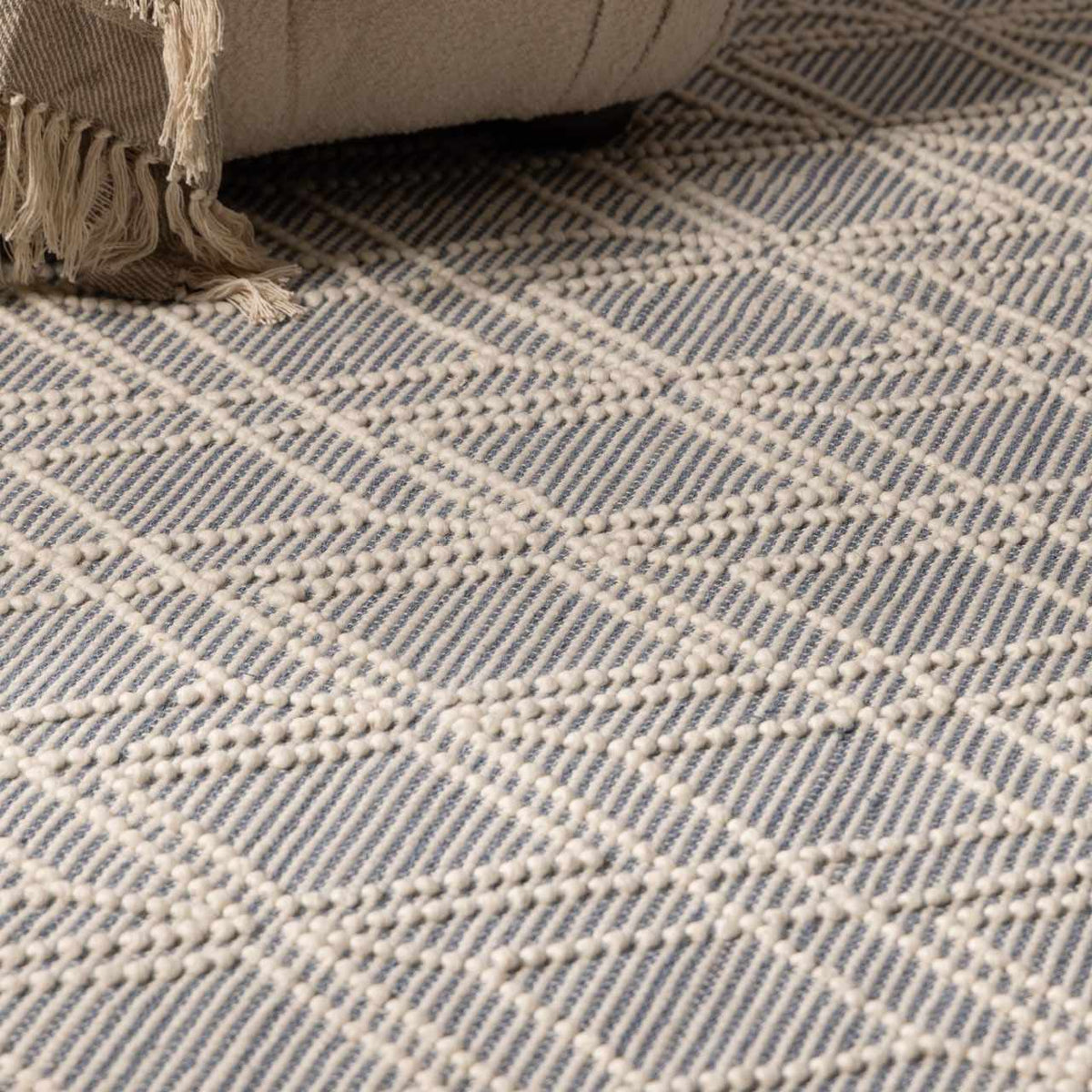 Blue wool rug from Ramsbury Denim collection by Boutique Rugs, displayed in a cozy living room setting.