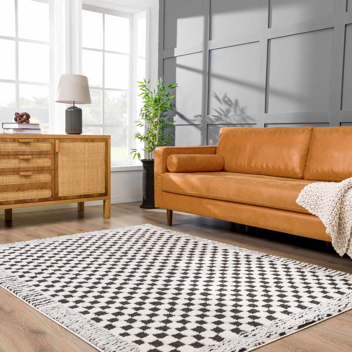 Black and white checkered area rug by Boutique Rugs, shown in a stylish room setting with modern decor.