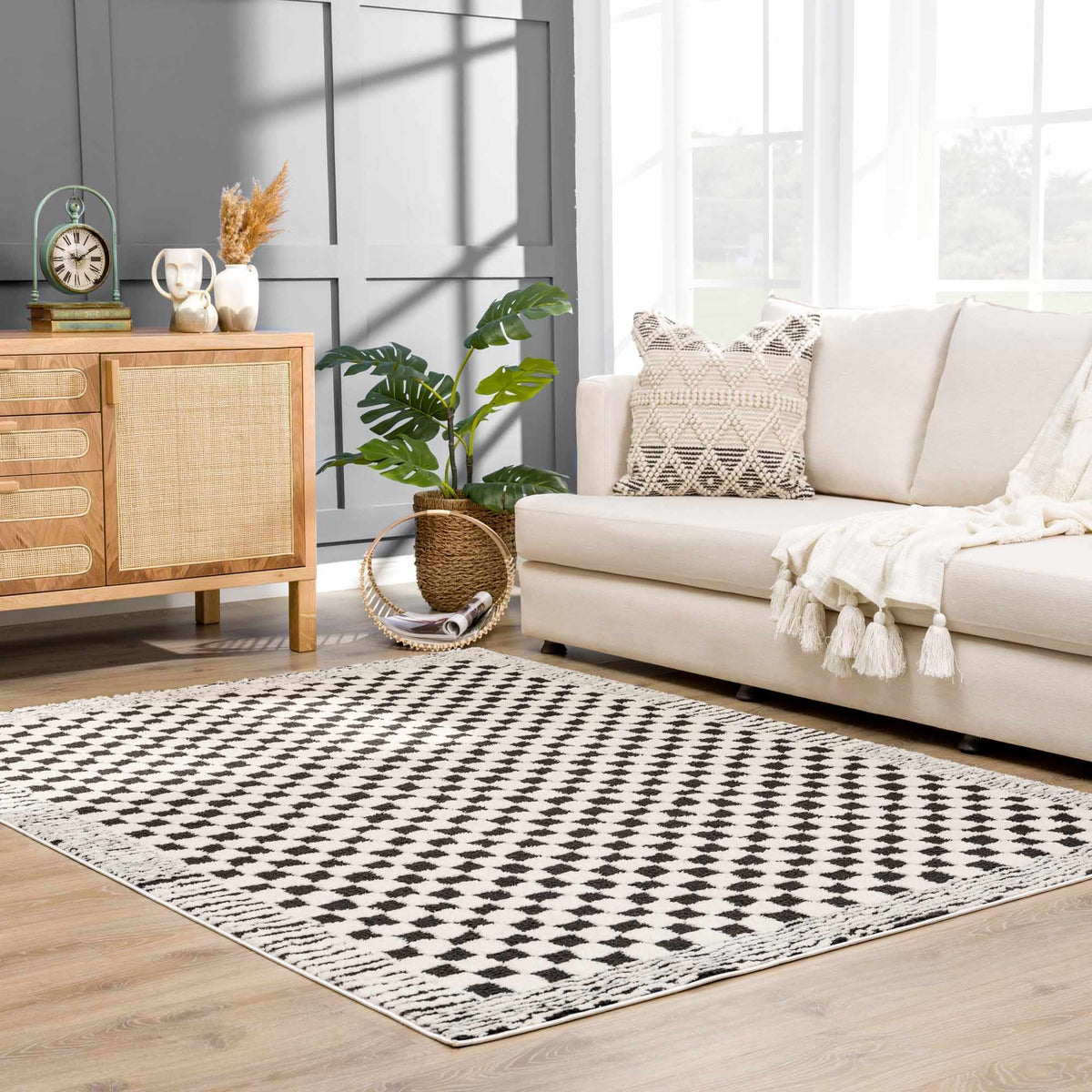 Black and white checkered area rug by Boutique Rugs, shown in a cozy room setting with furniture and decor.