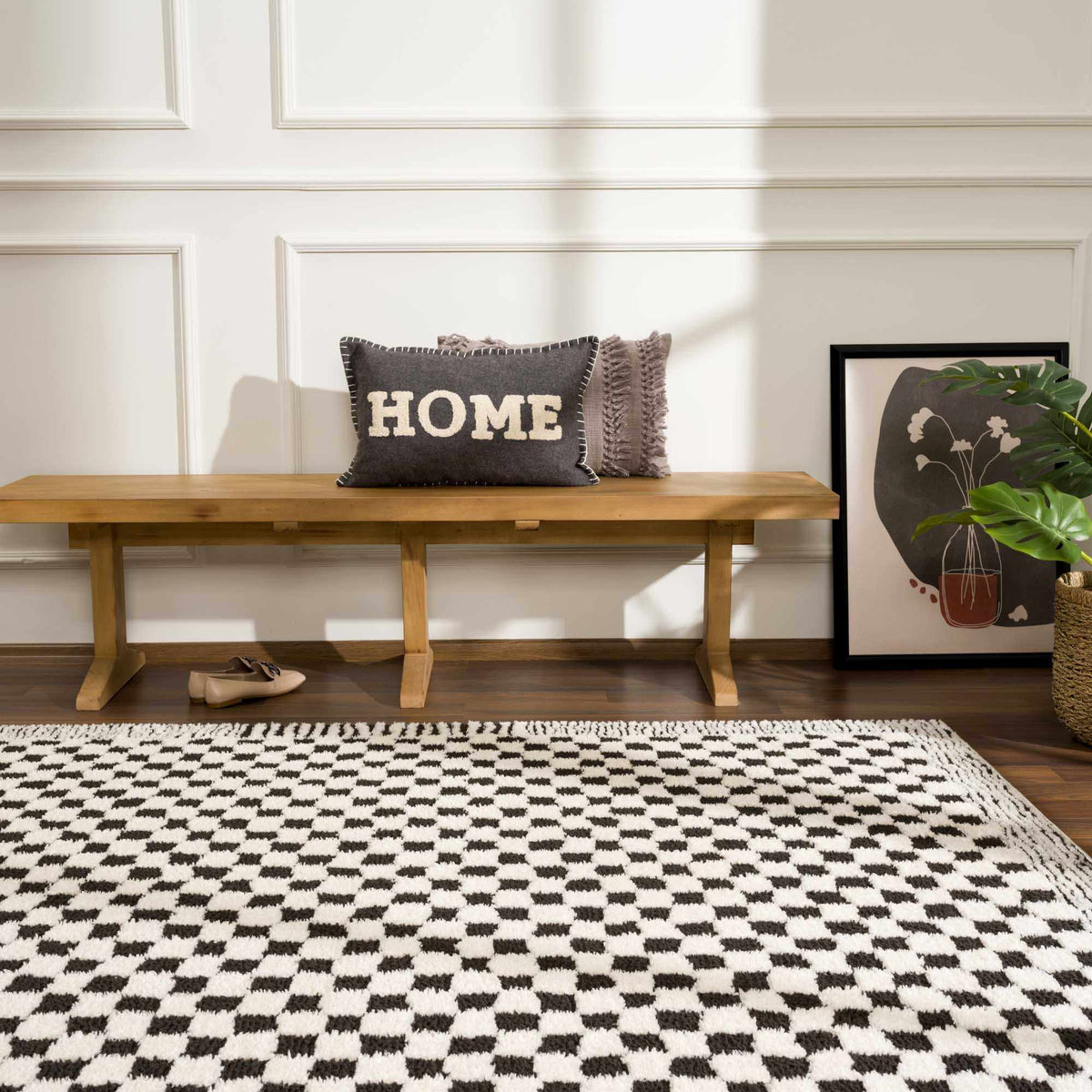 Black and white checkered area rug from Boutique Rugs, shown in a modern room setting with furniture and decor.