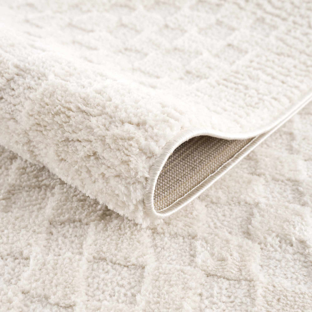 Leryn Ivory Checkered Area Rug from Boutique Rugs, showcasing a soft checkered pattern in light ivory tones on a neutral background.
