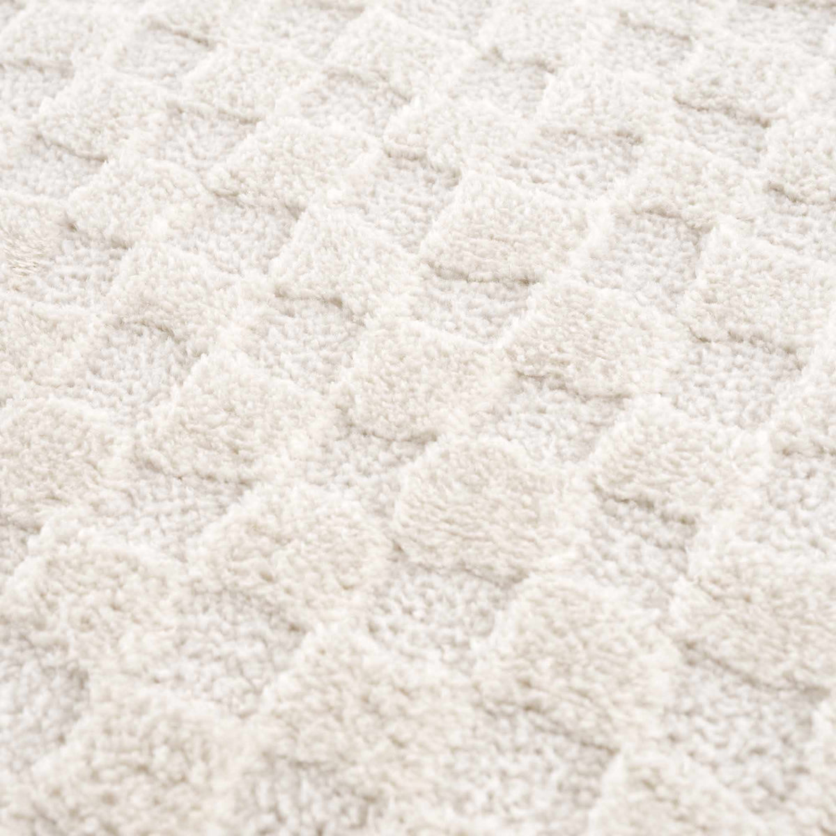 Ivory checkered area rug by Boutique Rugs, showcasing a textured fabric with a classic pattern suitable for living rooms and bedrooms.
