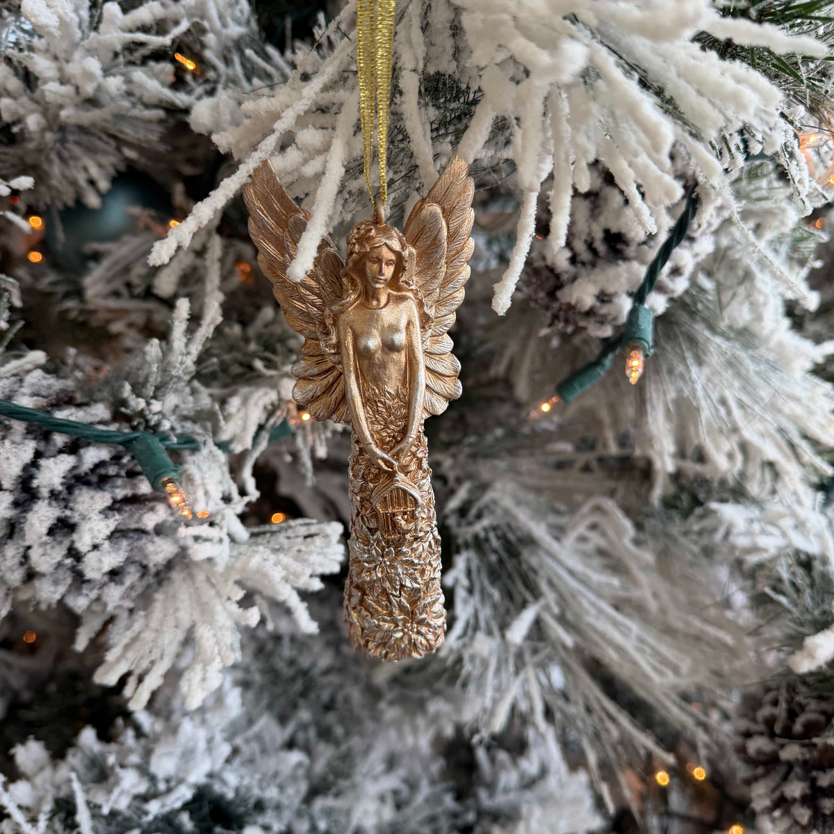 Gold angel Christmas ornament, 5.5 inch decorative tree topper from Shop Holly J Home, with intricate details and a festive design.