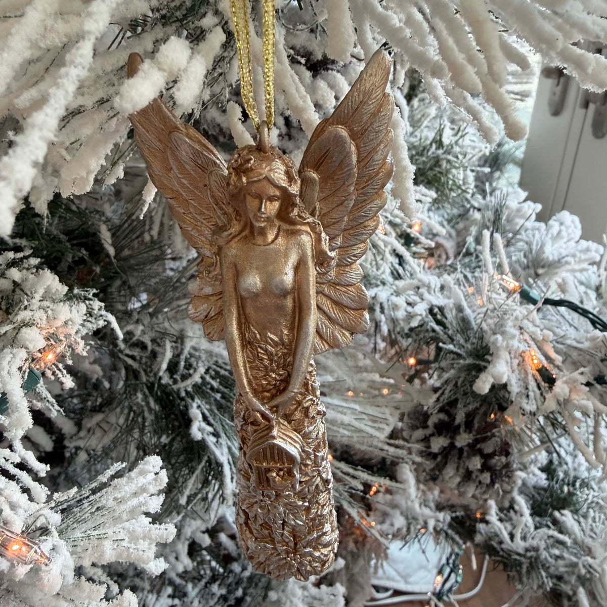 Gold angel Christmas ornament, 5.5 inches tall, decorative holiday tree decoration with intricate detailing.