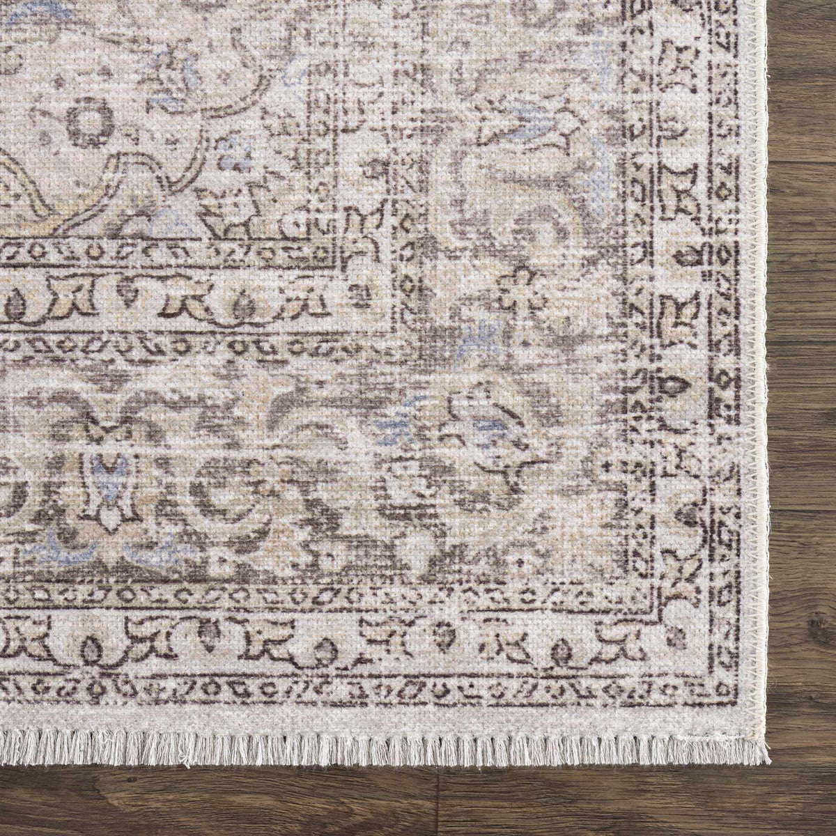 Corner view of Hauteloom Cream Holi-2301 washable area rug with intricate pattern, soft texture, and durable design.