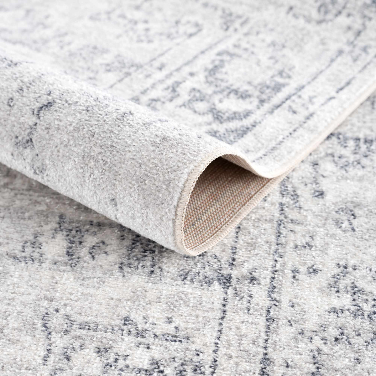 Folded Akram Antrasit flat pile washable rug by Boutique Rugs, showcasing soft, durable gray rug with a plush texture.