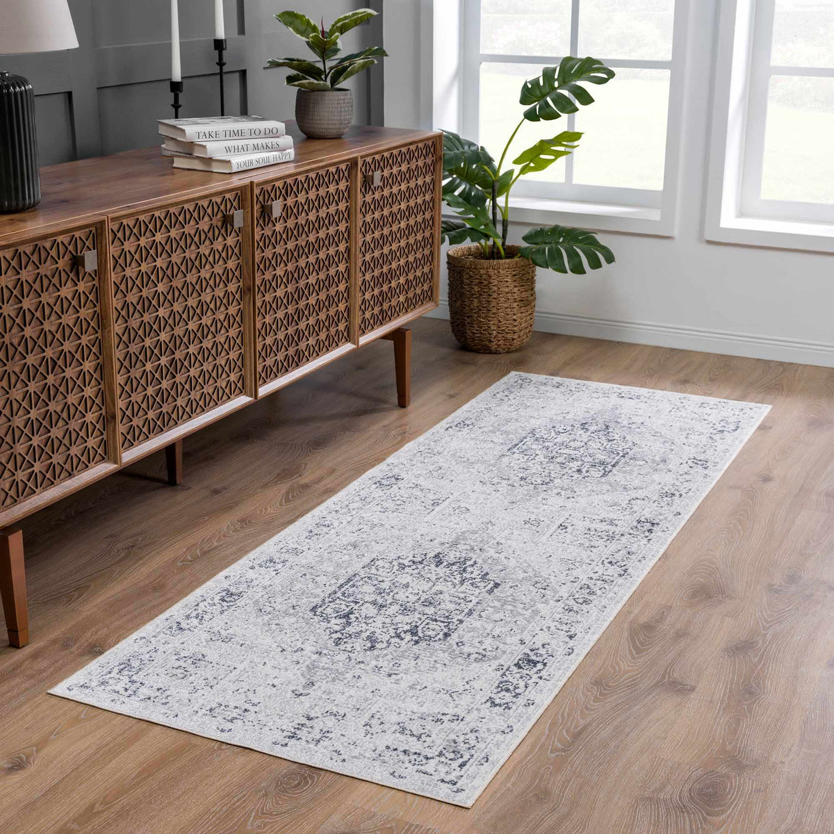 An Akram Antrasit flat pile washable rug by Boutique Rugs displayed in a modern living room setting.