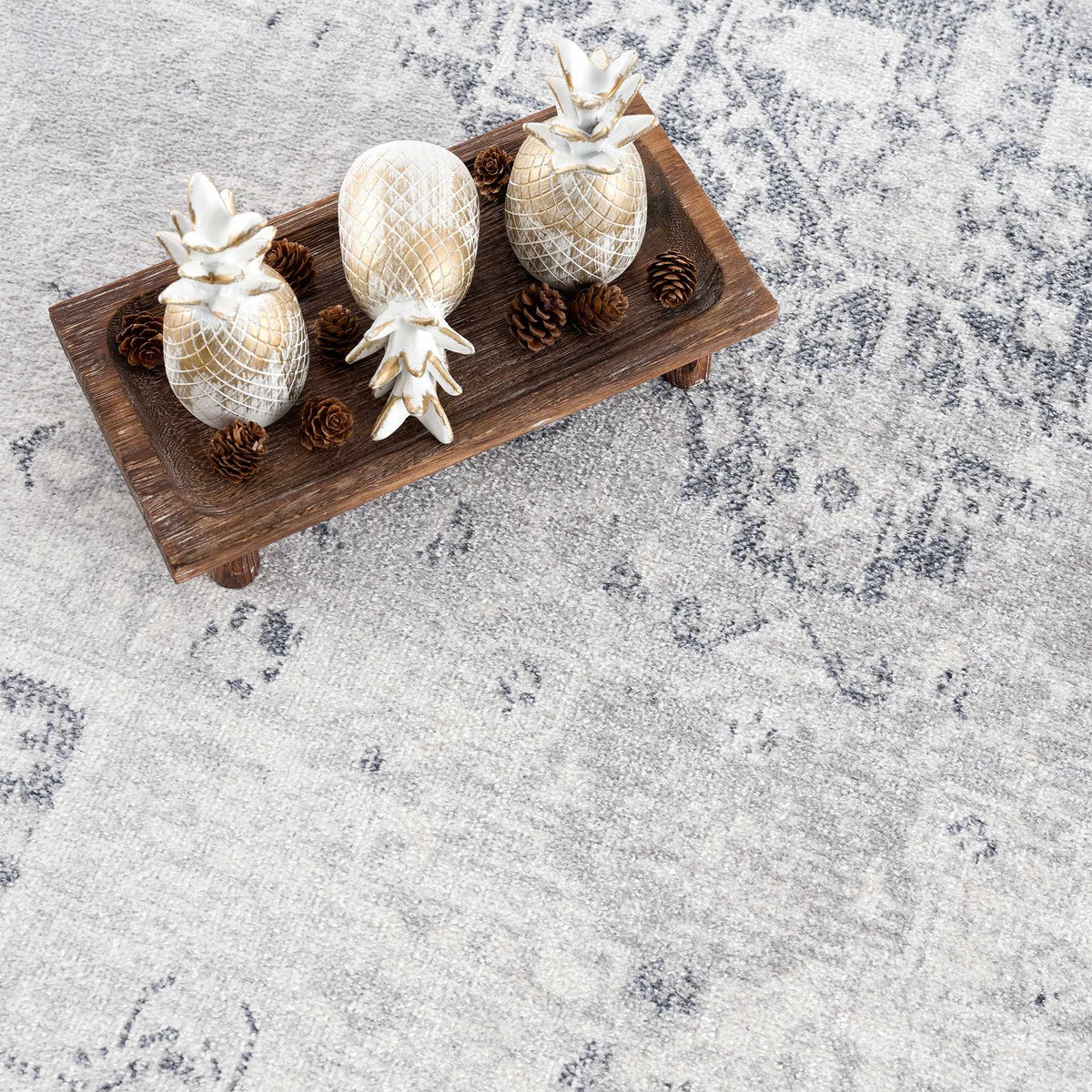 Boutique Rugs Akram Antrasit flat pile washable rug with a soft, textured surface in dark gray, shown in a stylish studio setting.