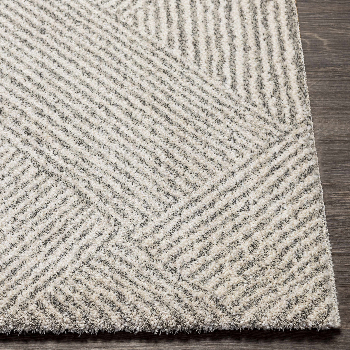 Horsley area rug by Boutique Rugs featuring a detailed, patterned design in neutral tones, displayed on a wooden floor.
