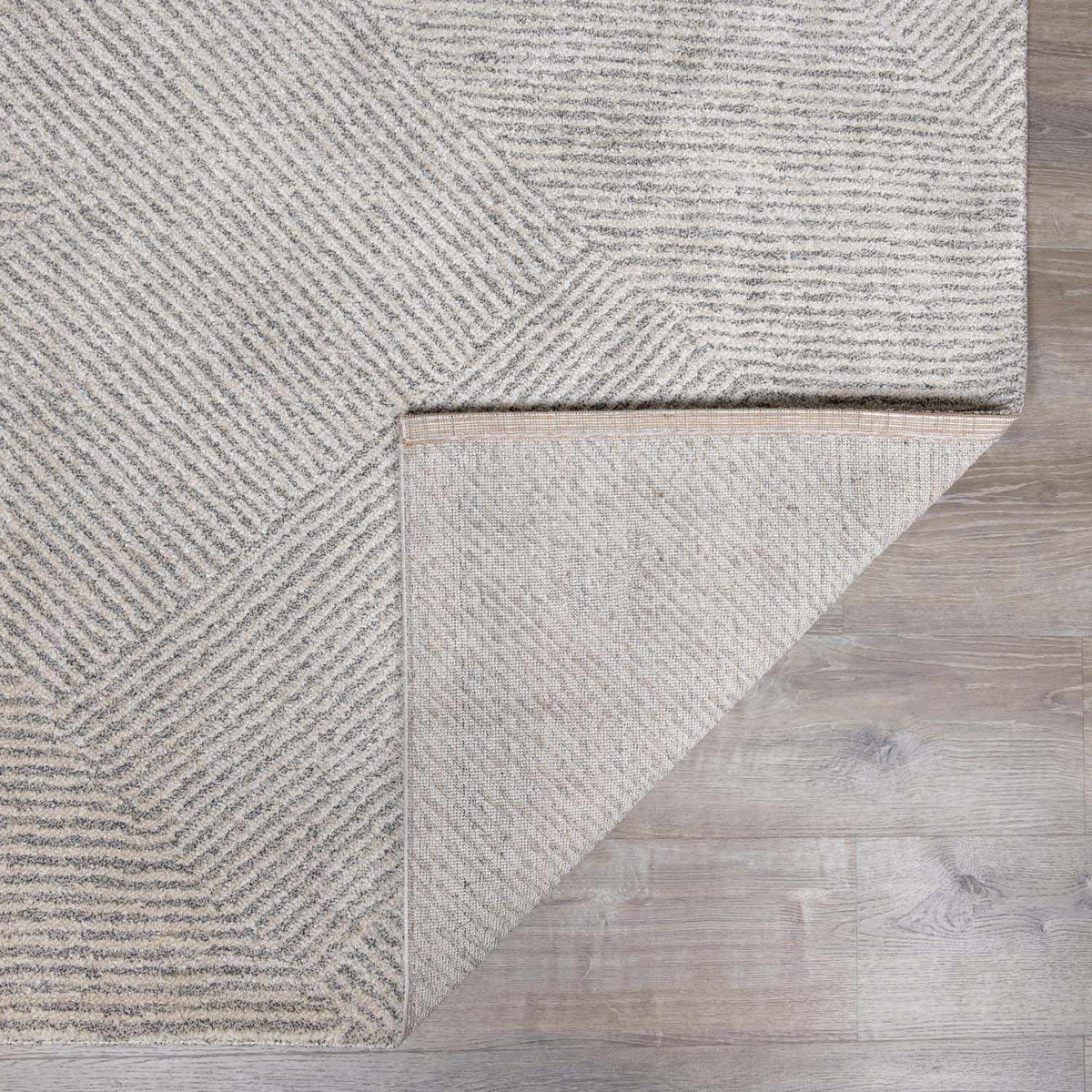Folded Horsley area rug by Boutique Rugs showing a textured, neutral-toned rug with intricate pattern details.