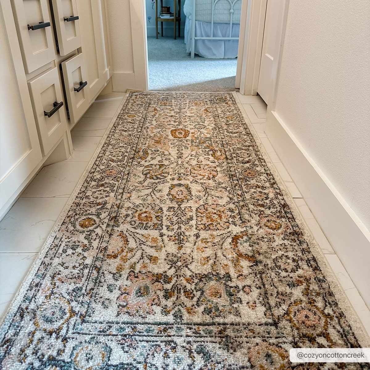 Herstmonceux area rug runner by Boutique Rugs, 2x7 feet, featuring cozy cotton design in neutral tones on a wooden floor.