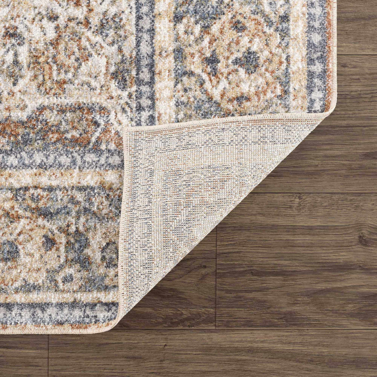 Blue washable rug from Boutique Rugs' Arias Blue Boutique collection, shown folded with soft textured fabric.