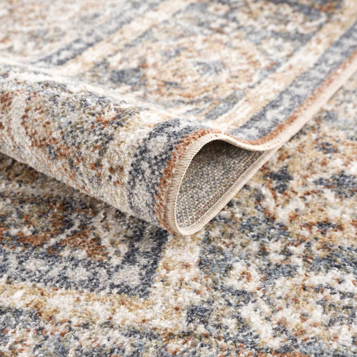 A blue Boutique Rugs washable rug folded, showcasing soft texture and vibrant color, ideal for contemporary home decor.