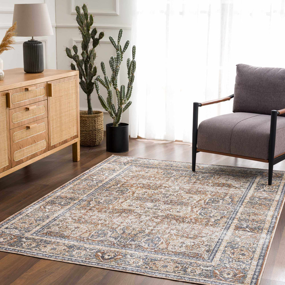 A blue Boutique Rugs washable rug displayed in a modern living room setting with furniture and decor.