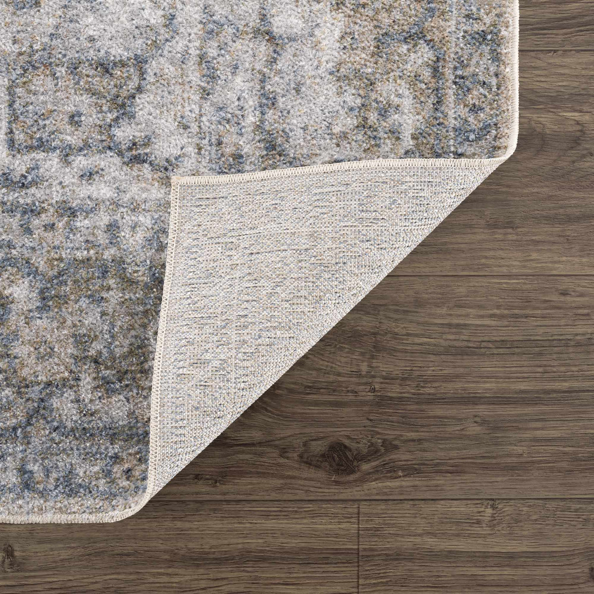 Blue Boutique Rugs Gael washable rug with folded corner, showcasing soft fabric and stylish design on a neutral background.