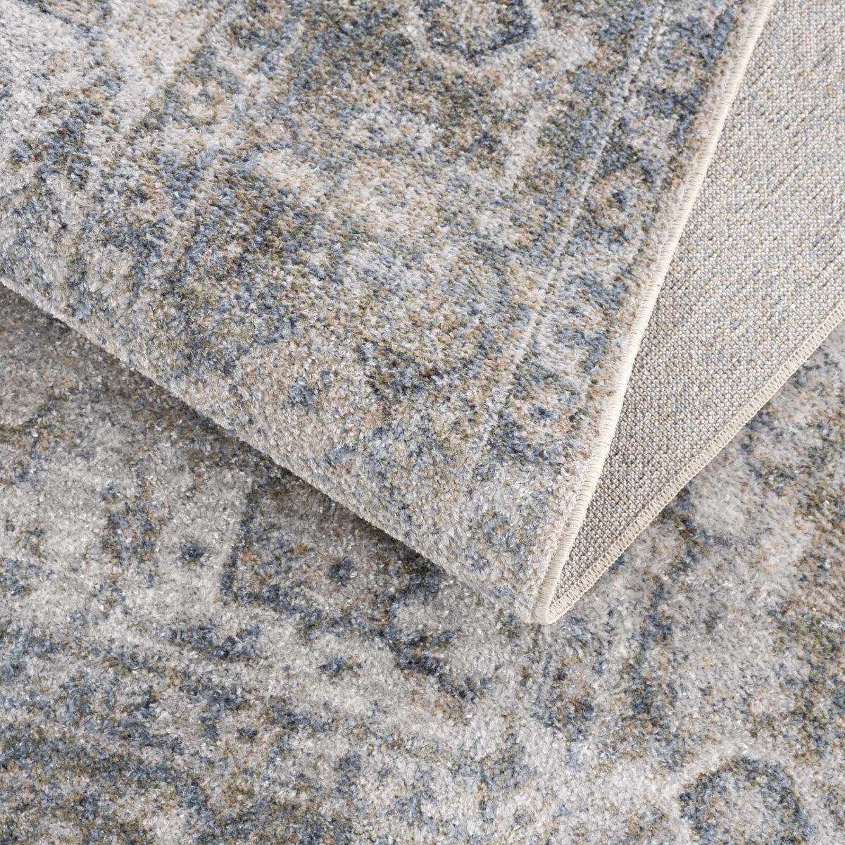 Folded Gael Blue Boutique washable rug from Boutique Rugs, showcasing soft fabric texture and vibrant blue color.