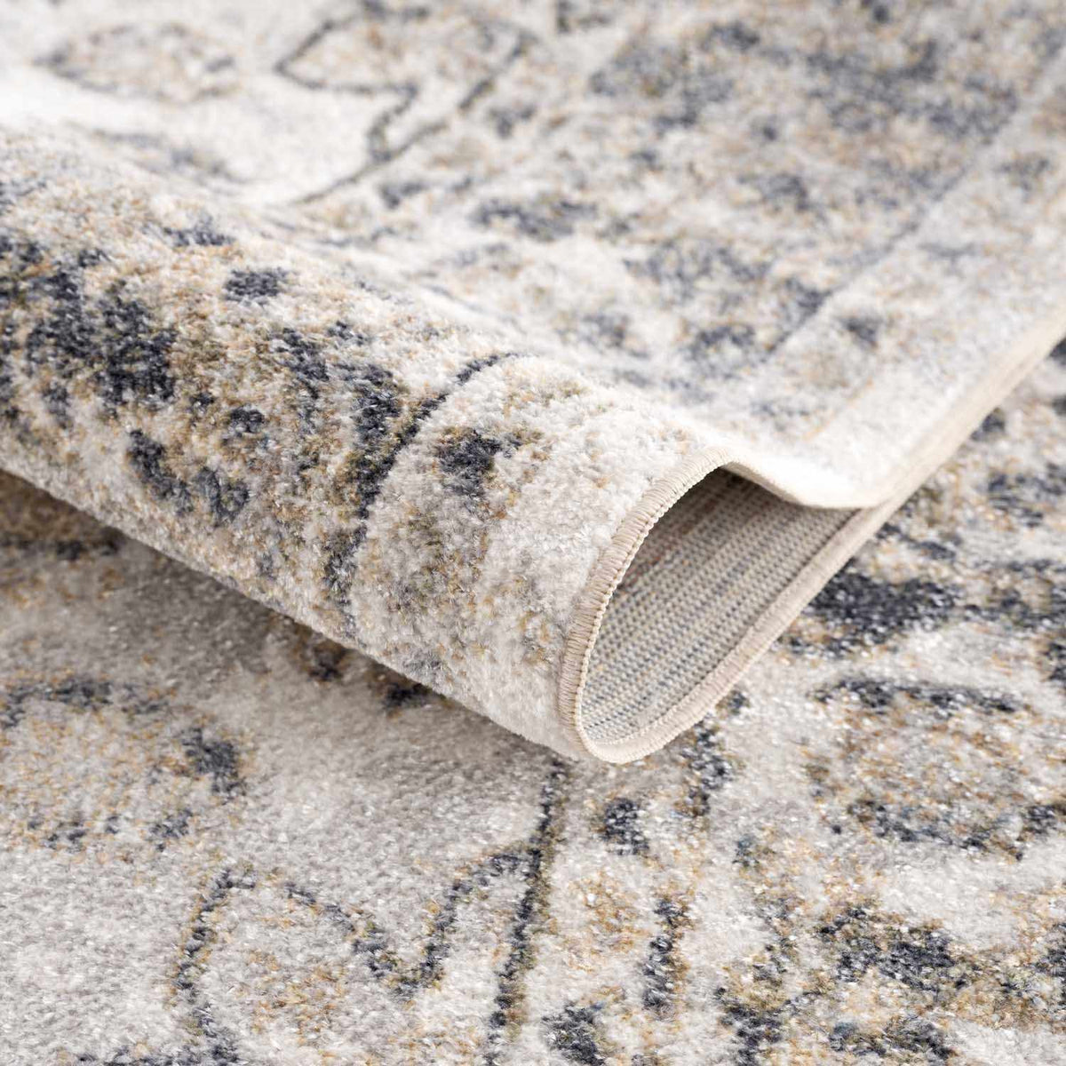 Beige washable flat pile rug by Boutique Rugs, folded to show soft texture and durable design, ideal for modern home decor.