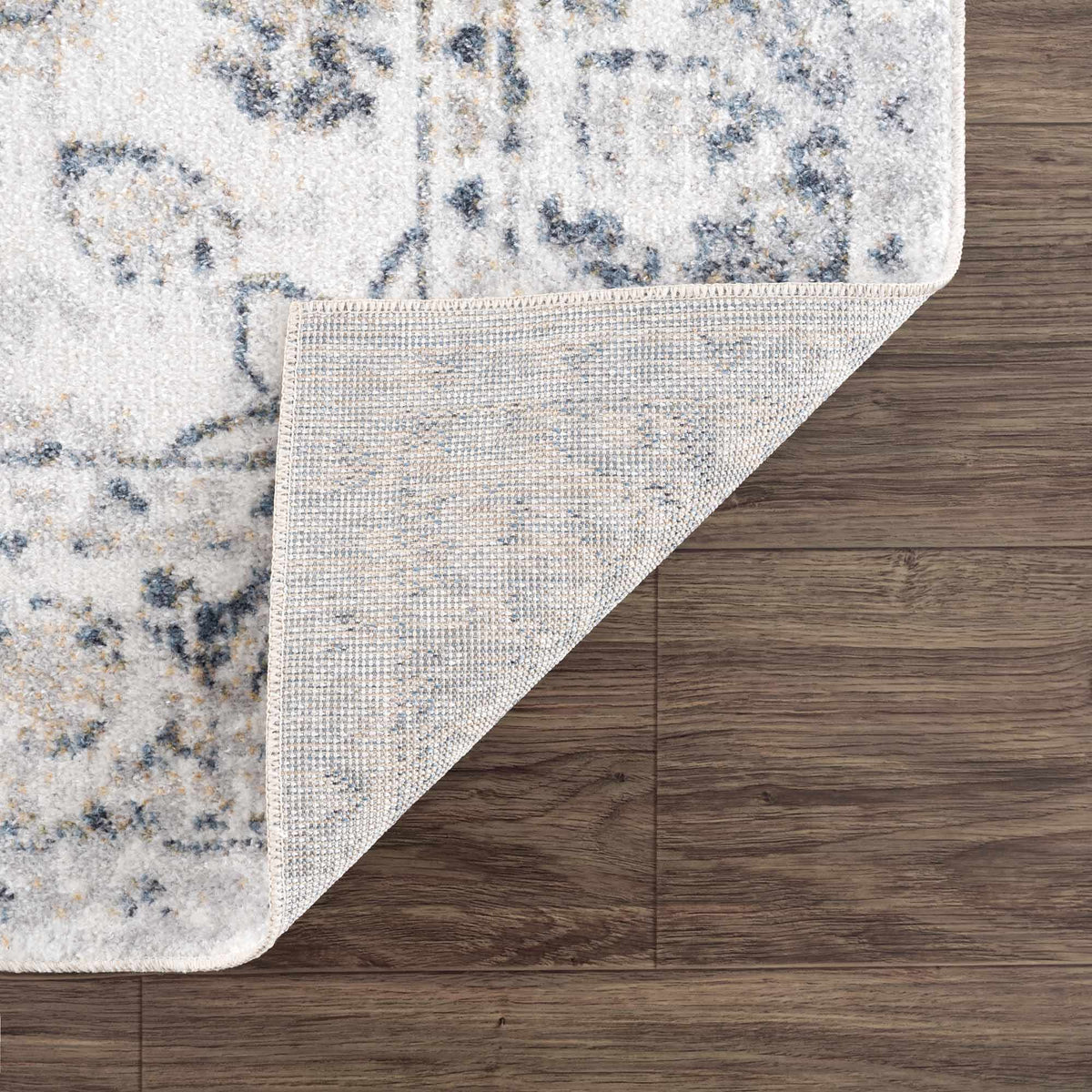 Folded Rudo Flat Pile Washable Rug by Boutique Rugs, showcasing soft texture and durable design in neutral tones.