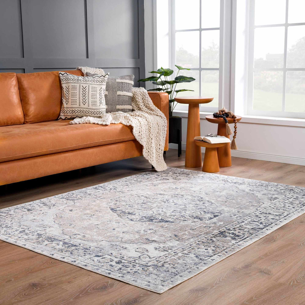 Rudo Flat Pile Washable Rug by Boutique Rugs in a cozy living room setting with neutral tones and textured surface.