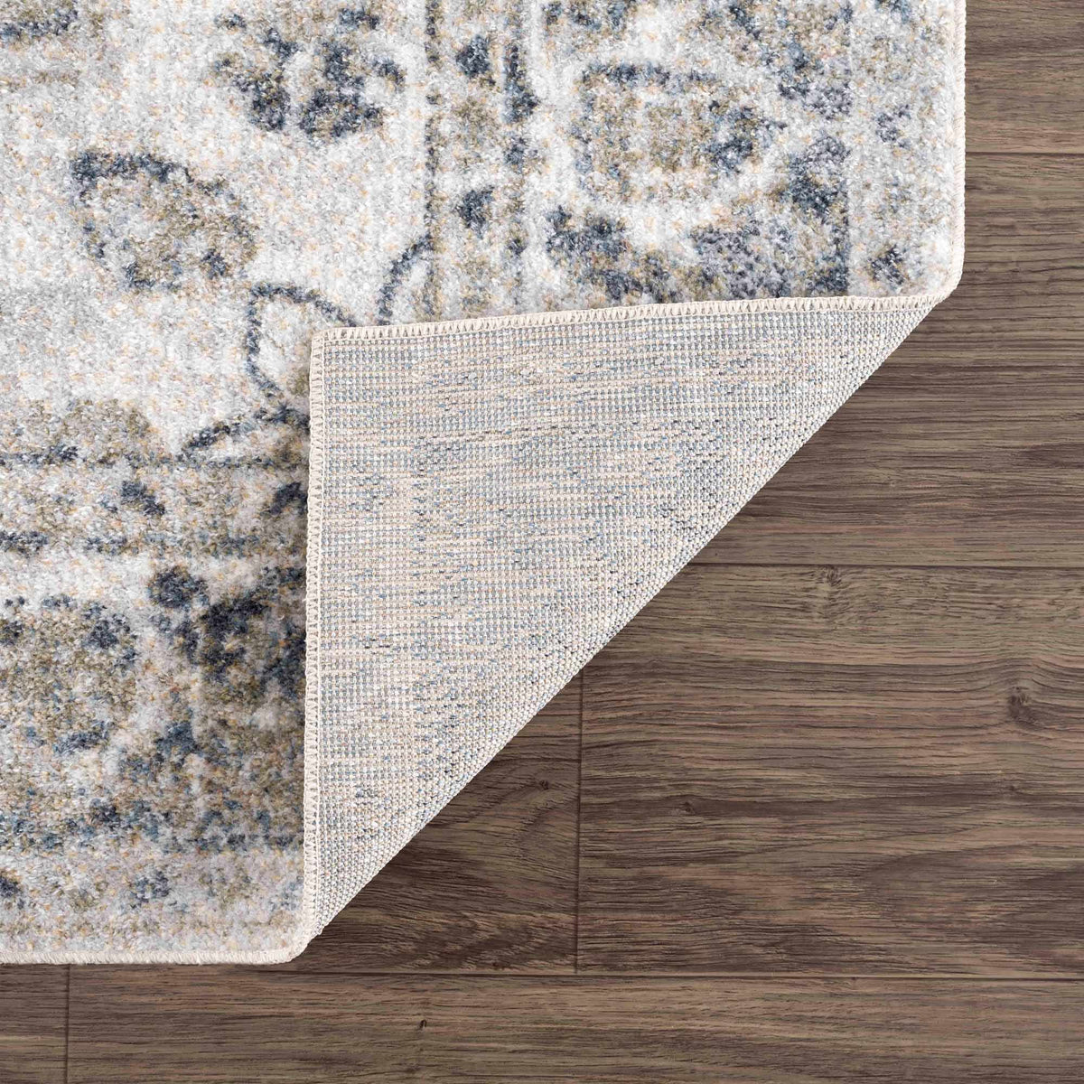 Folded Rudoblu Boutique washable rug from Boutique Rugs, showing its soft fabric and textured surface in a cozy indoor setting.