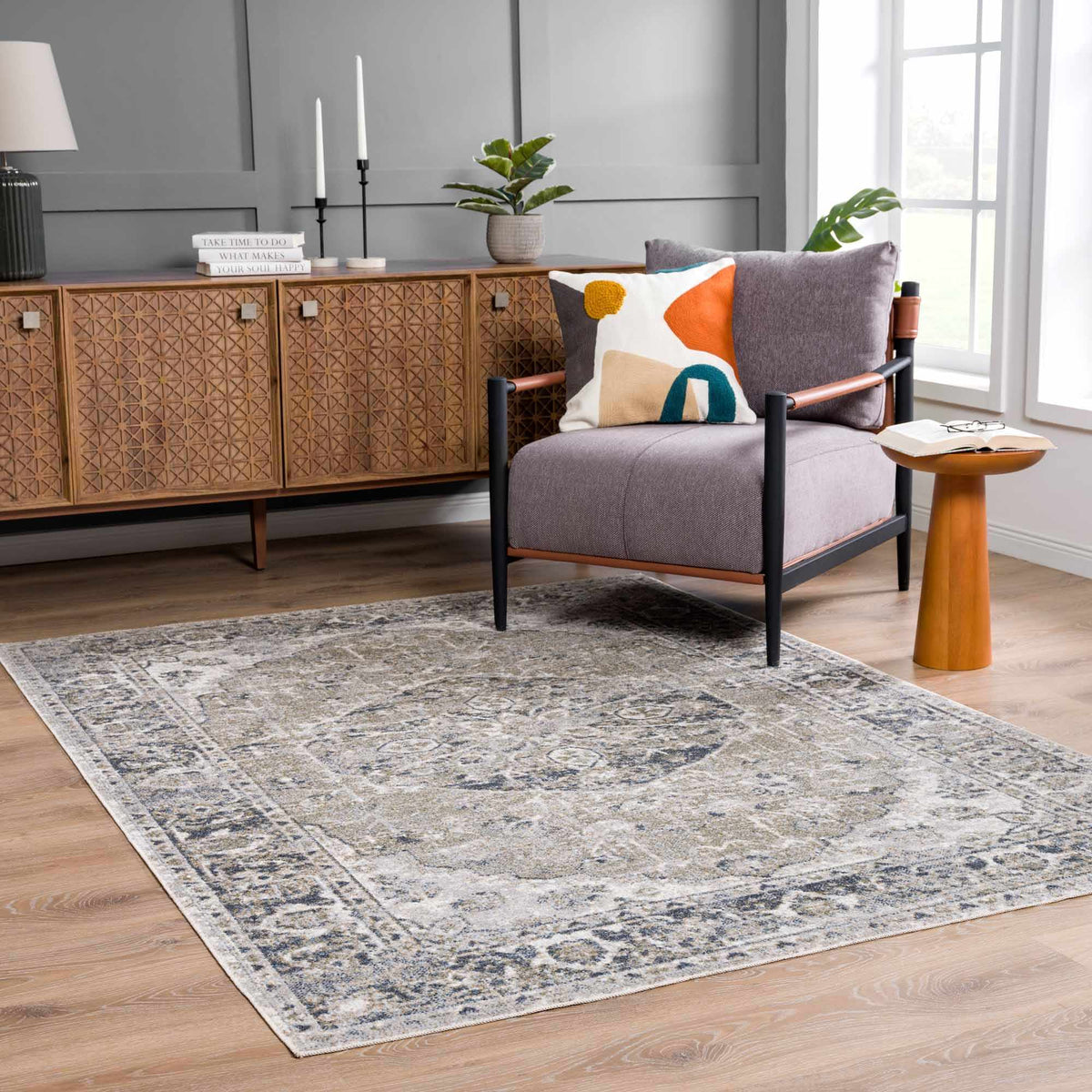Warm-toned Rudoblu Boutique washable rug by Boutique Rugs displayed in a cozy room scene with furniture and decorative pillows