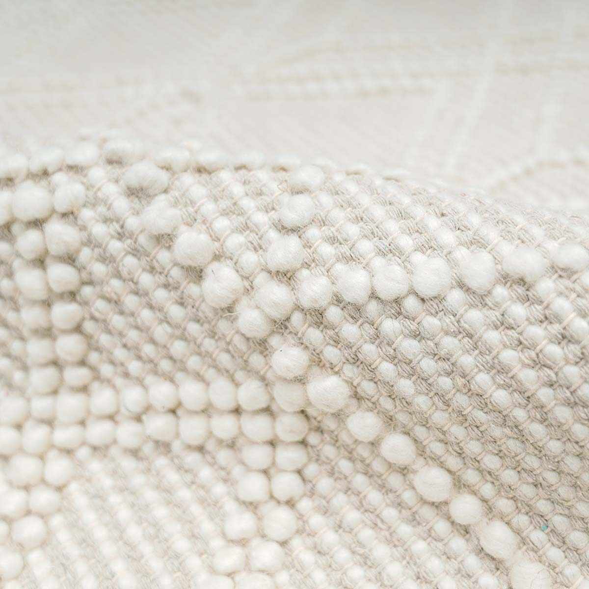 Boutique Rugs Ramsbury Beige Trellis Wool Rug with intricate geometric pattern and soft texture, displayed on a wooden floor.