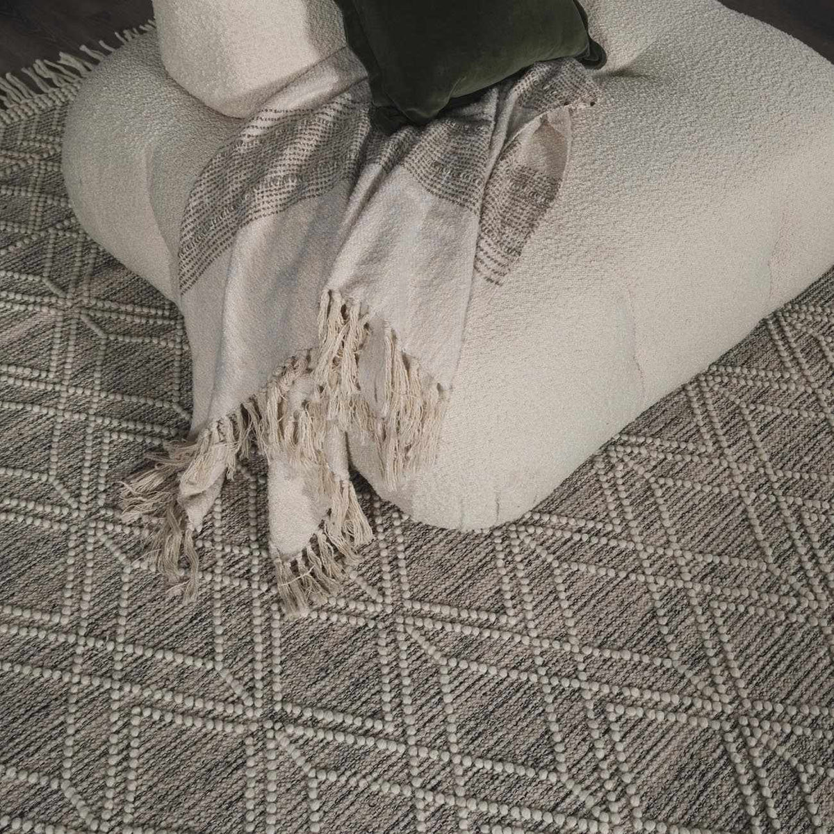Beige trellis wool rug by Boutique Rugs displayed in a cozy living room setting with furniture and decor.