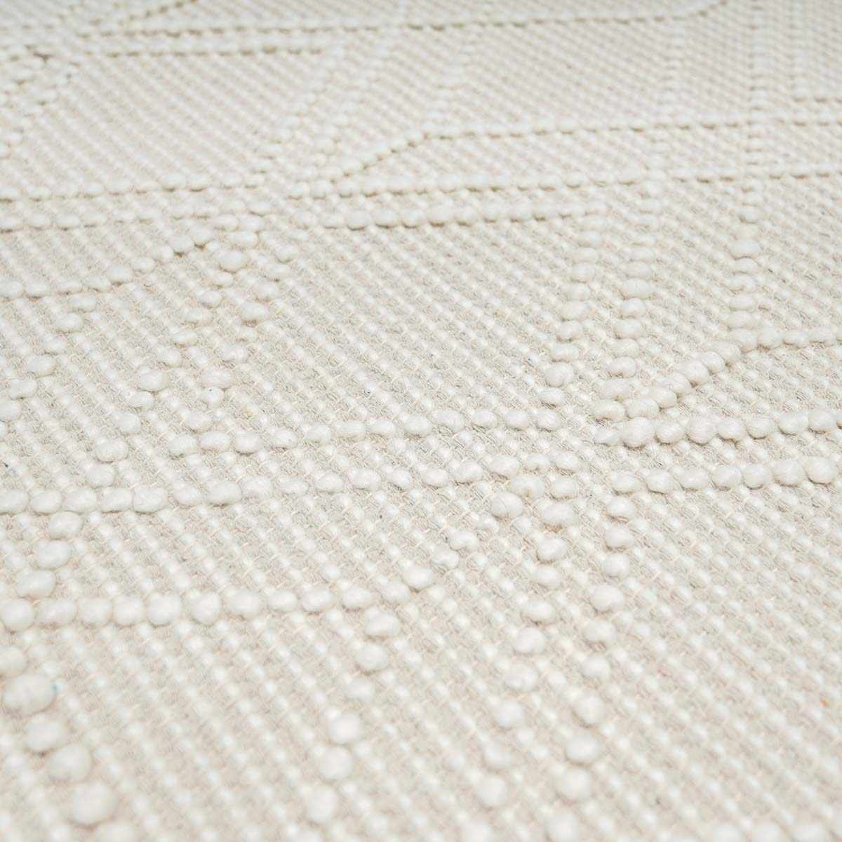 Beige trellis wool rug from Ramsbury by Boutique Rugs, showing textured pattern on soft, high-quality wool surface.