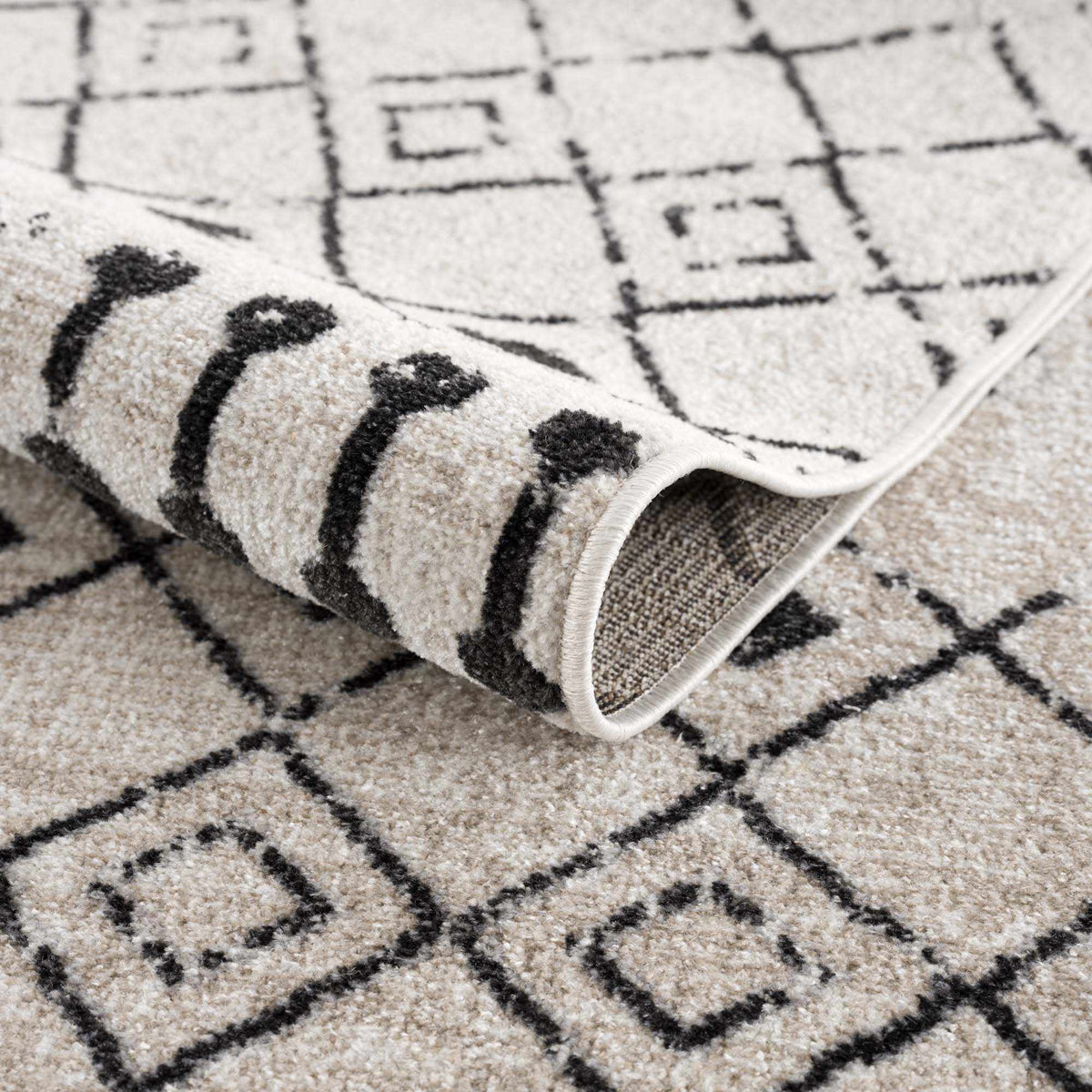 Folded Joppatowne washable area rug by Boutique Rugs, showing soft fabric and textured design in a cozy indoor setting.
