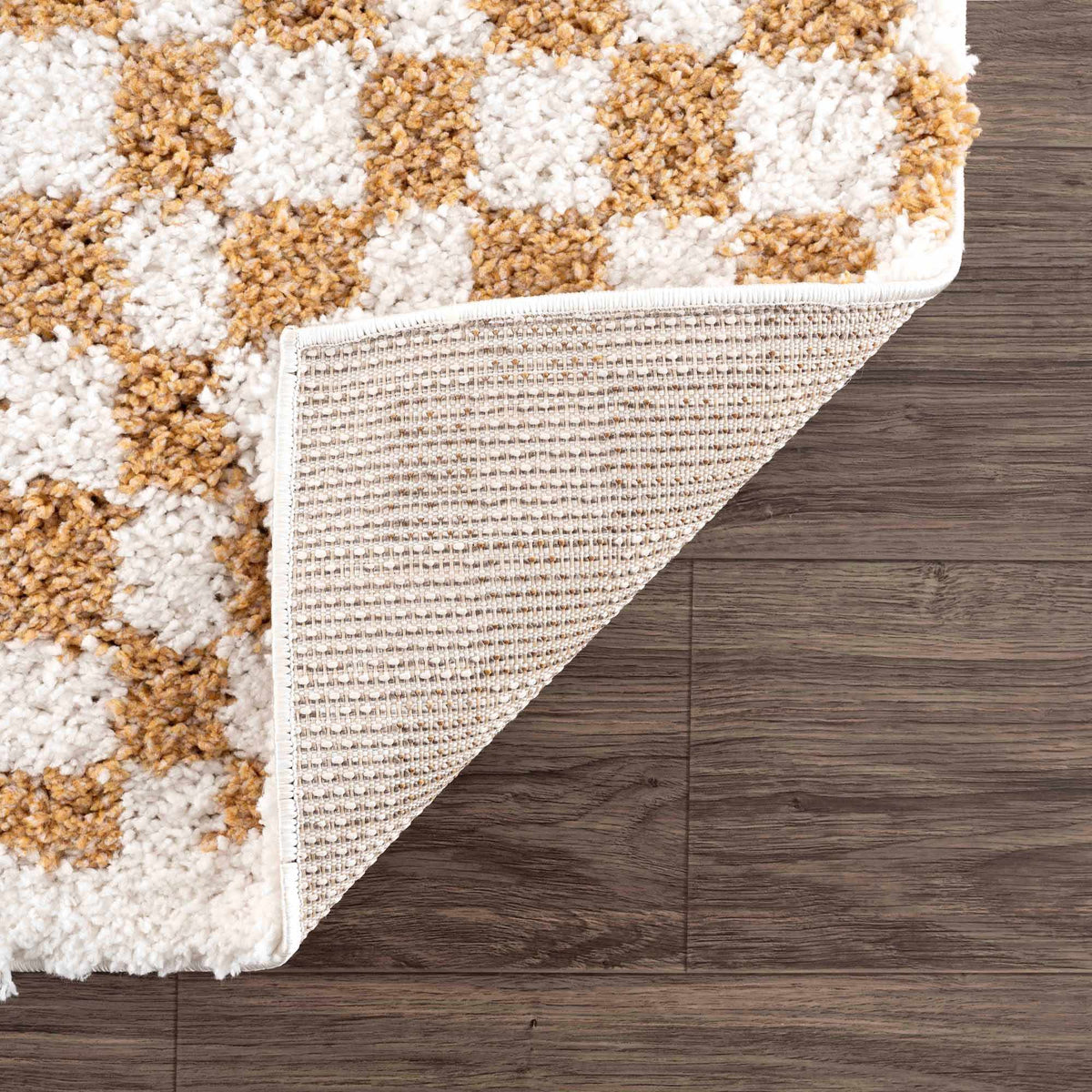 Kieu Mustard and Ivory Checkered Area Rug from Boutique Rugs, folded display showing its soft woven fabric and checkered pattern.