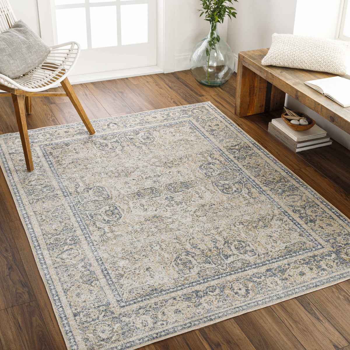 A washable Boutique Rugs Arias Boutique rug in neutral tones displayed on a floor in a modern room setting.
