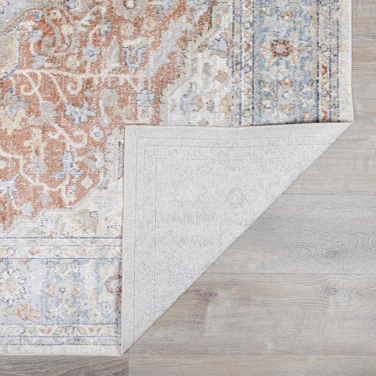 Boutique Rugs Emke flat pile washable rug folded, showcasing its soft texture and neutral color for easy home decor.