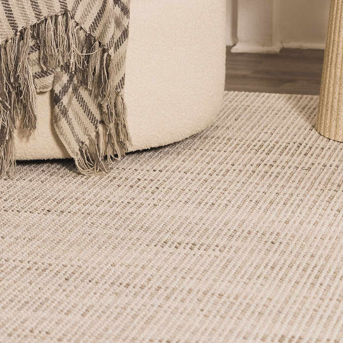 Cream Gowan area rug by Boutique Rugs shown in a cozy living room with furniture and decorative accents.