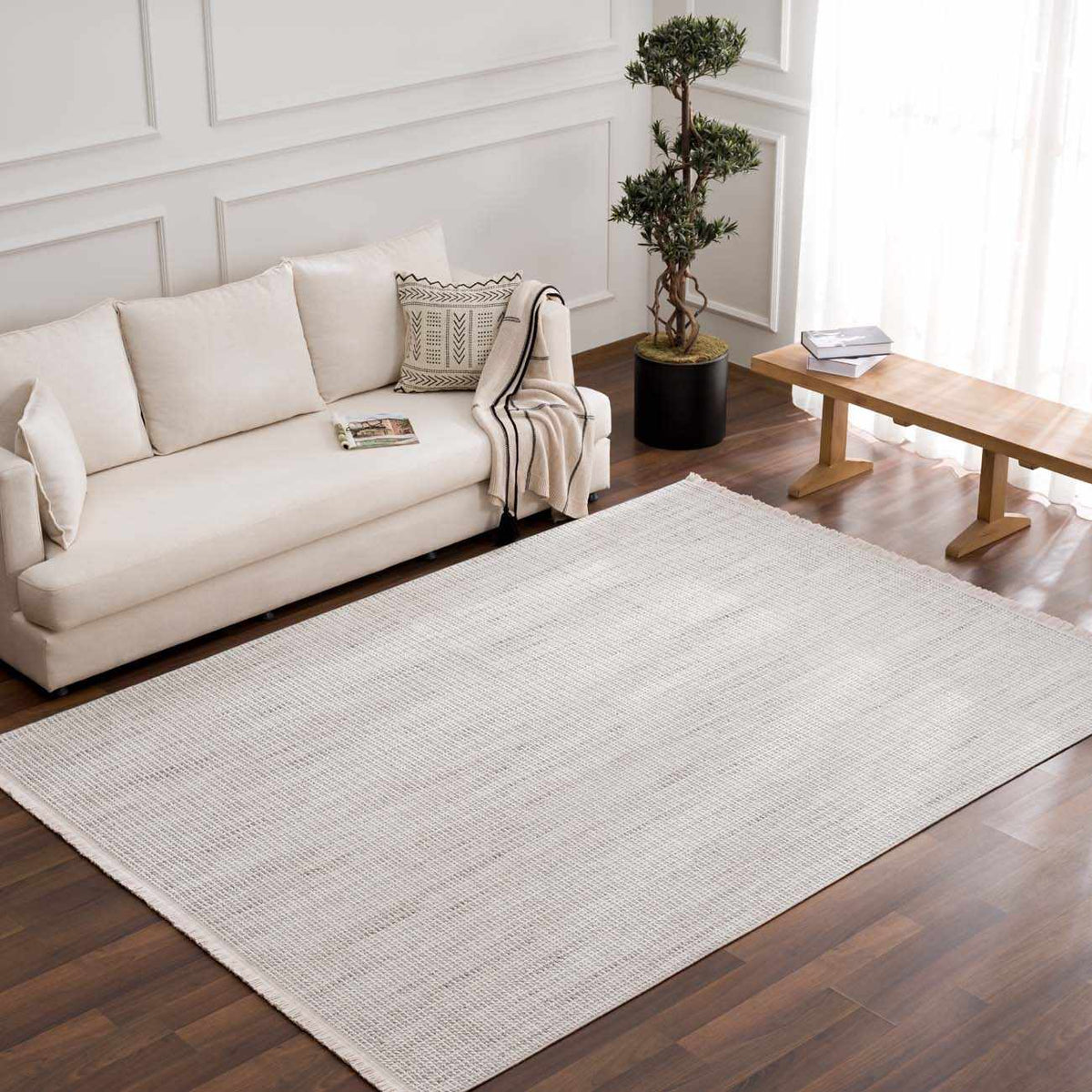 Gowan Cream Area Rug by Boutique Rugs, cozy living room scene featuring a soft, cream-colored rug on wooden floor.